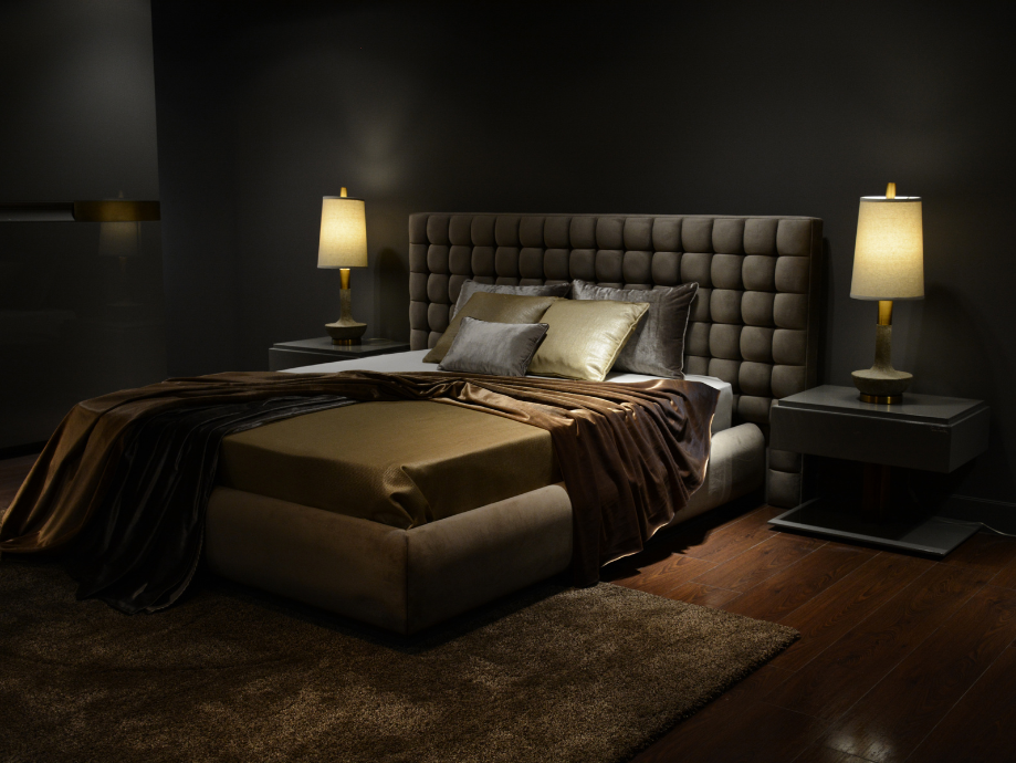 Luxury bedroom with gold bedspread and warm light lamps